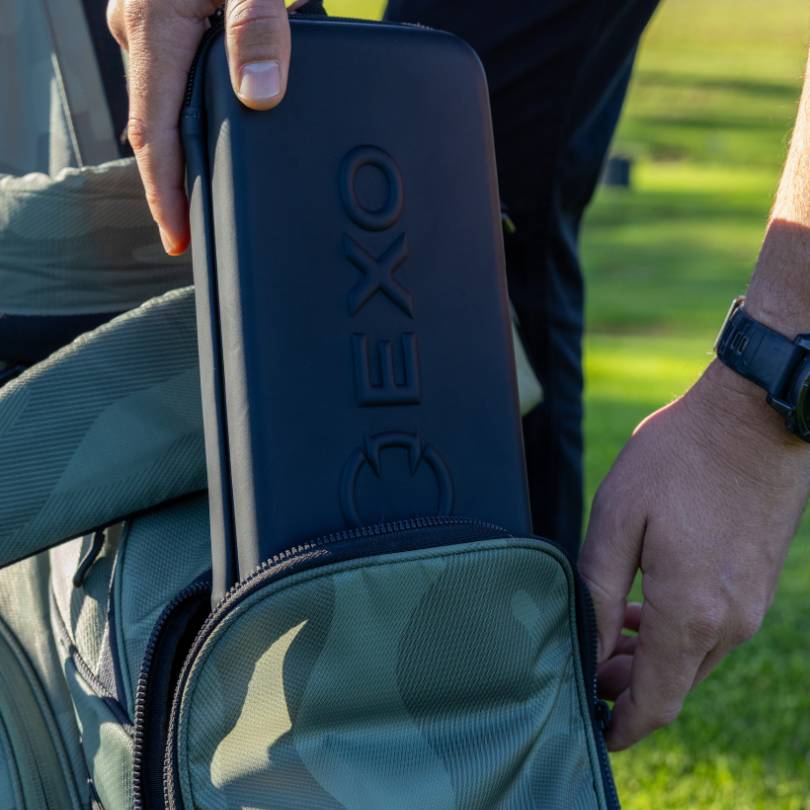 EXO glove case - closed with visible EXO logo - golfer packing the case into the bag