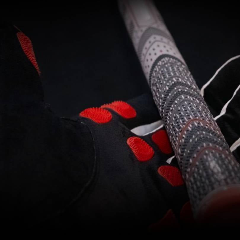 EXO Golf Glove with red nanocell holding a golf club