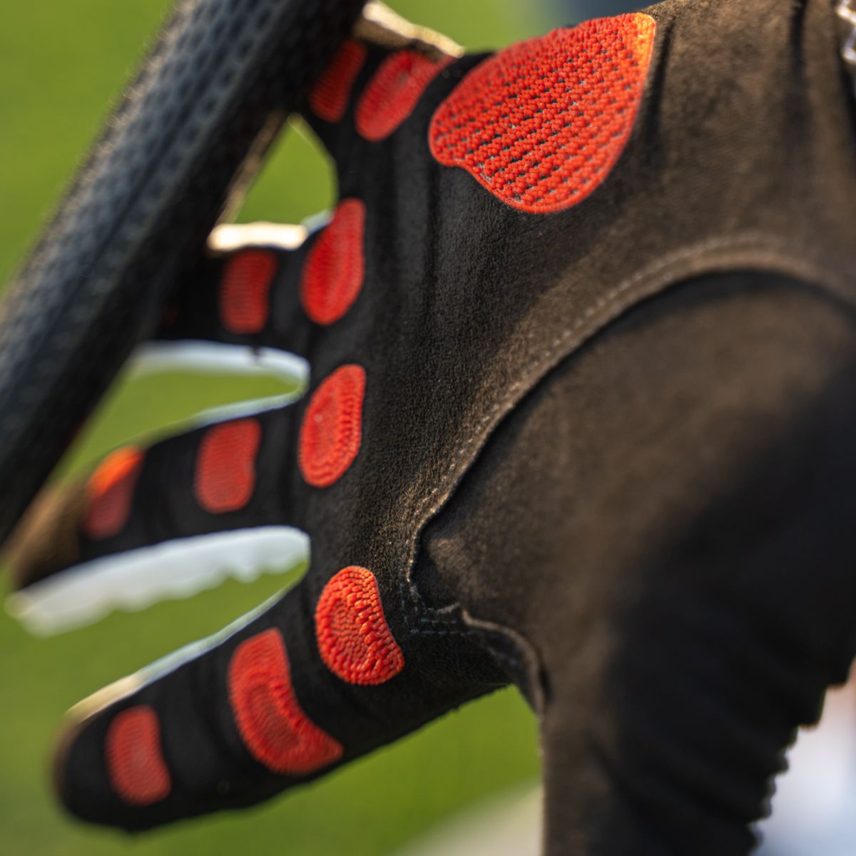 EXO Golf Glove with red nanocells - palm stretched out about to grip the club