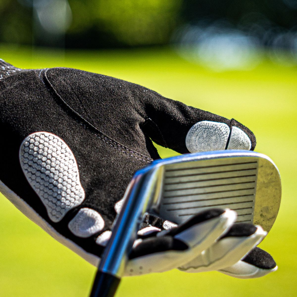 EXO Golf Glove withe white nanocells howling the head of a golf club